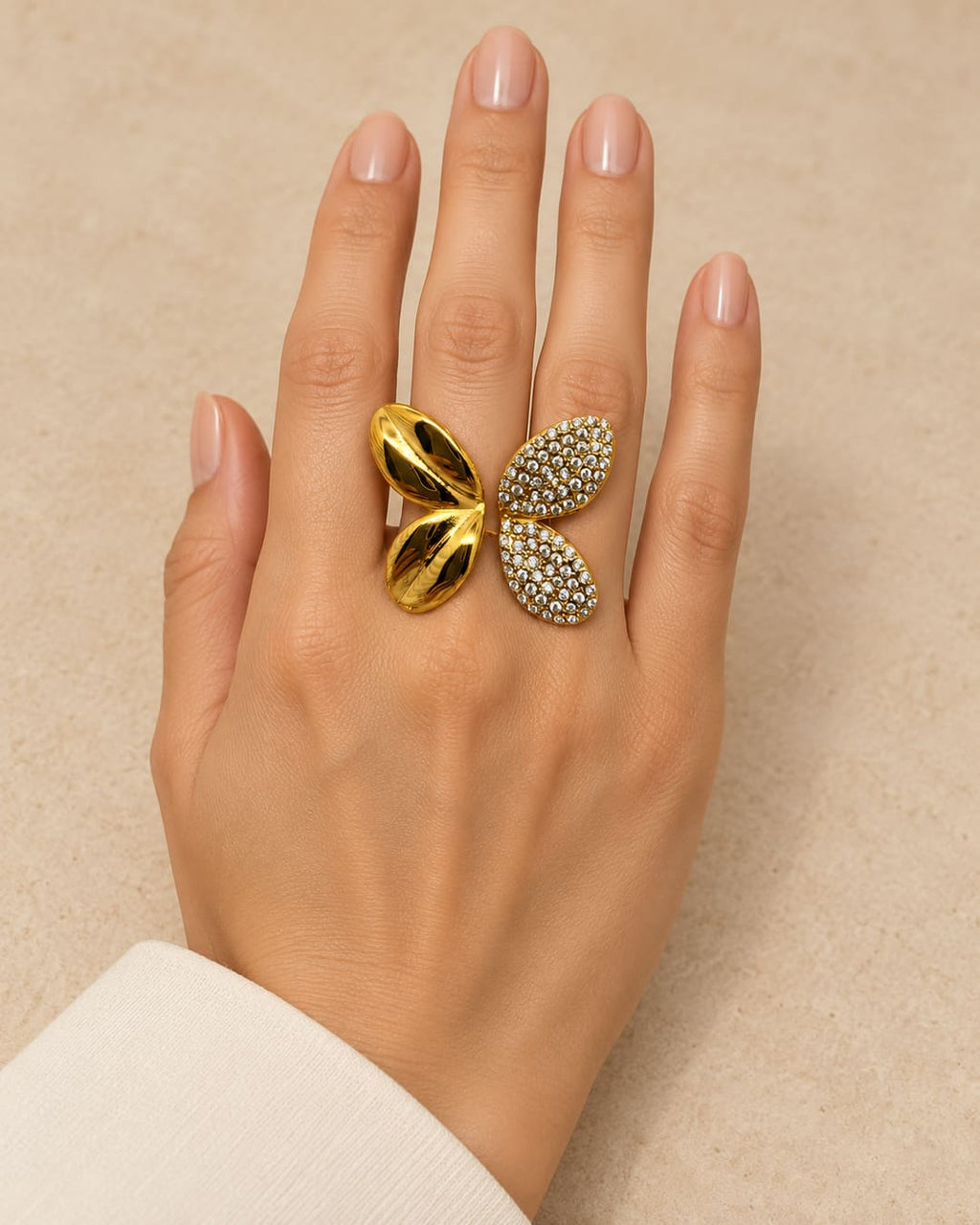 Anillo mariposa brillos, sobre mano de modelo, orientación y escala corregidas